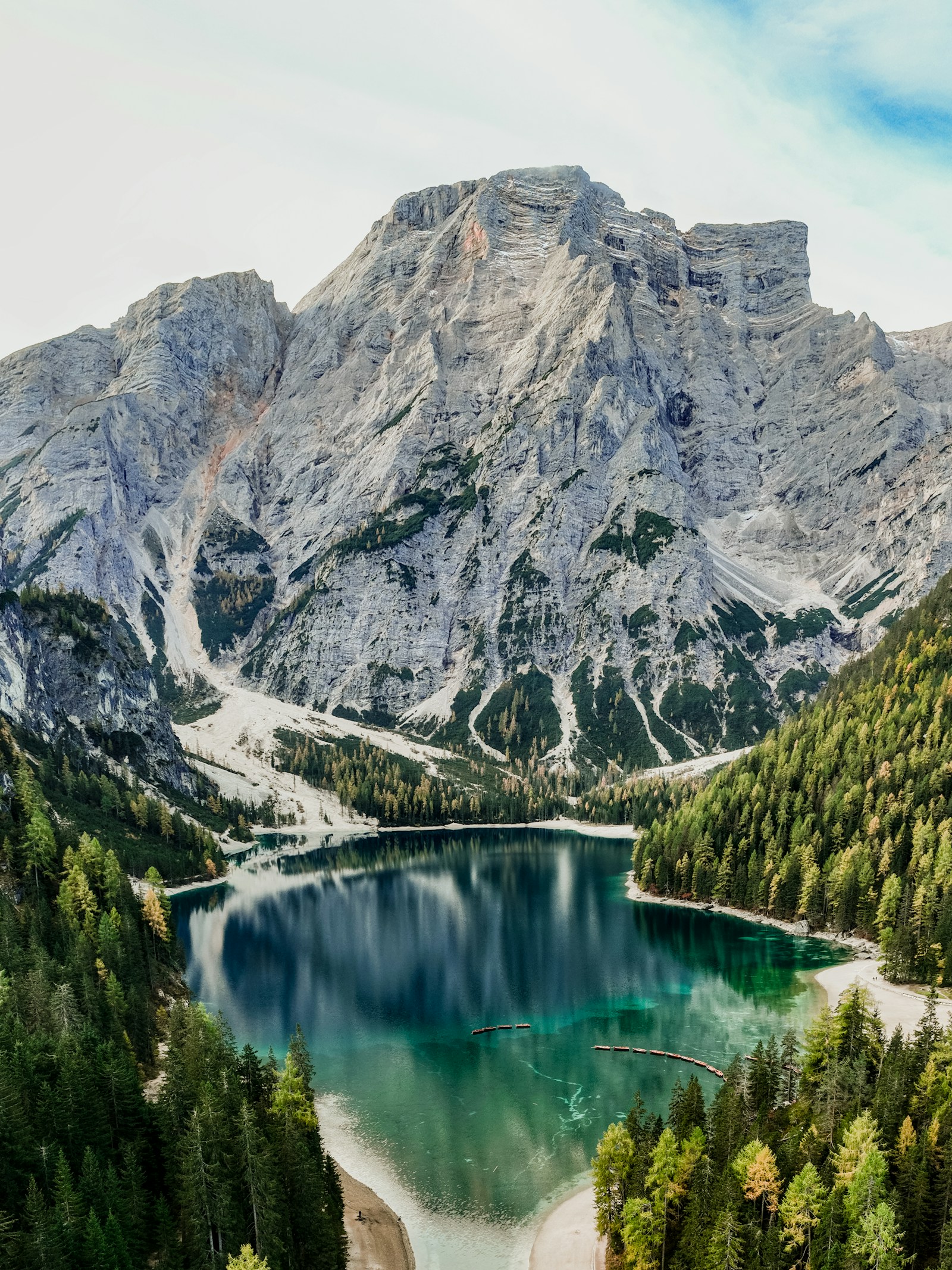 Turquoise alpine water surrounded by forest and mountains